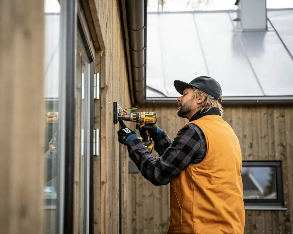Electrician fitting an outdoor fixture