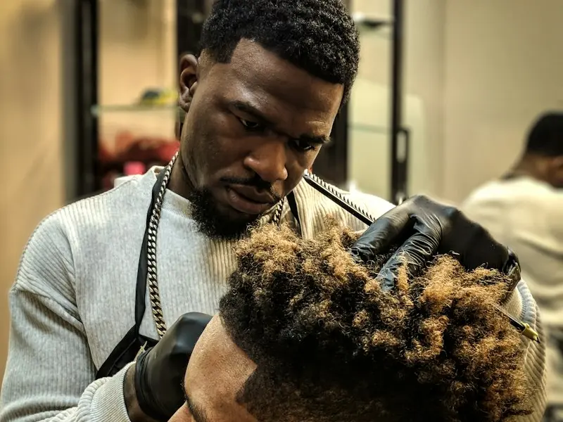 A barber giving a client a fade